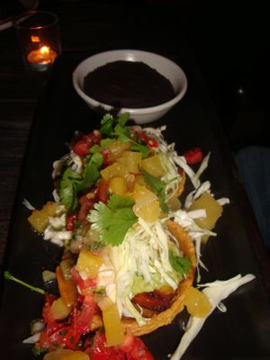 SOPAS CON PIÑA
Two masa cakes with guacamole, pineapple habanero salsa, pickled cabbage, cashew crema and cilantro. Served with beans at Gracias Madre - WeHo in West Hollywood