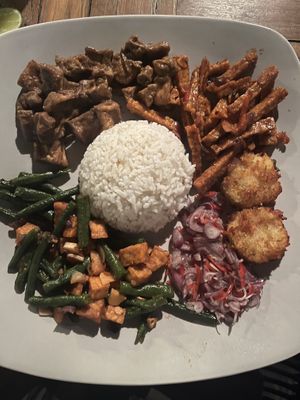 Nasi Campur: tofu with peanut butter, sweet and sour tempe, tempe with long beans, potato fritters  at Warung Gayatri in Abang