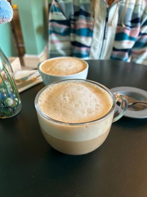 Chai Latte with Oat Milk (foreground), and Latte with Oat Milk (background) at Delicious   in Harrogate