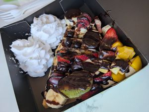 Vegan and gluten-free fruit topped waffle. Coconut whip and dark chocolate. at Juice Dudez in Ottawa