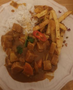 Steamed Jasmine rice, himalayan fries, Malaysian curry with plant based chicken. at Peppery Rose Alderley Edge in Alderley Edge