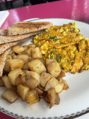Scrambled tofu with cheese, tomato & onion served with soft melt in your mouth peppered potatoes   at Mamalicious in Hamburg