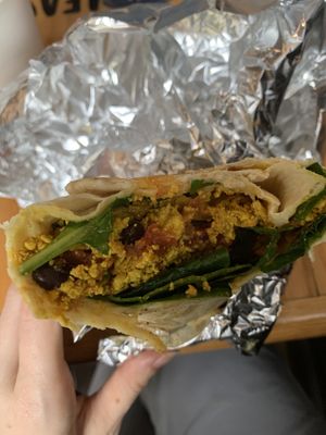 Vegan breakfast burrito with tofu scramble, black beans, spinach, vegan sausage, a spicy “mayo”, and a few other things. Delicious   at The Sentient Bean in Savannah