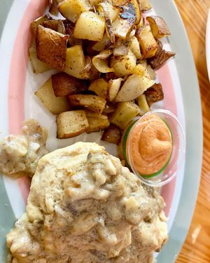Vegan sausage gravy and biscuits with potatoes. Not sure what the sauce is but it was delicious with the potatoes with a little bit of a kick. at The Sentient Bean in Savannah