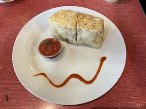 Vegan Breakfast Burrito- tofu scramble, house vegan sausage, spinach, black beans, vegan spicy mayo  at The Sentient Bean in Savannah