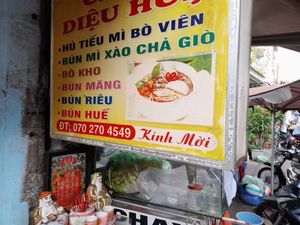 Sign outside with menu.  Name. Phone number at Diệu Hue in Ho Chi Minh City