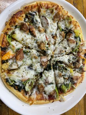 Hawaiian vegan cheese pizza with added tempeh, spinach and mushroom   at H&H Vegetarian Food & Pizza in Vang Vieng