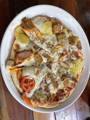 Hawaiian vegan cheese  pizza with added tempeh  at H&H Vegetarian Food & Pizza in Vang Vieng