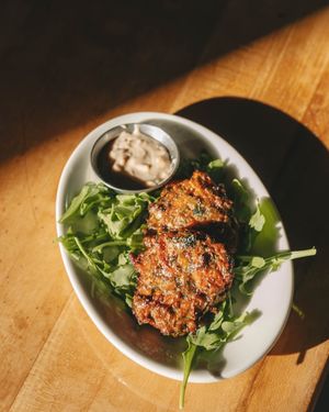 Carrot + Pistachio Fritters — lemon tahini, greens (winter 2025 menu) at Corridor in Indianapolis