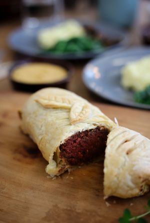 Pastrami Wellington comes with mustard mash, creamy duxelles and wilted spinach. at Kaiaroha Vegan Deli and Eatery in Auckland