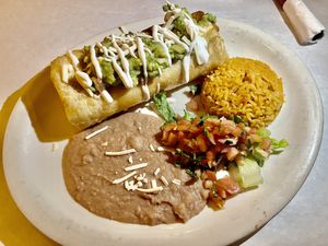 Chimichanga with  Egan upton’s chorizo, cheese, sour cream,  beans, salsa Fresca, and  rice  at La Cantina in Chicago