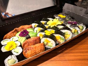 Different types of Sushi arranged with flowers, sideview at BBQ SUSHI MOMO in Gossau
