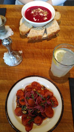 Top: carrot-beetroot soup with fresh focaccia bread. Bottom: smokey carrots and their homemade mandarine-scrub drink (like a lemonade/ "Sirup"). Delicious! at Kleinwäscherei in Zurich