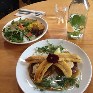 'Omelette' with salad and Kumara Hotcakes with maple syrup, banana, and macadamia nut butter at Little Bird Kitchen in Auckland