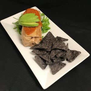 Southwest Burrito loaded with Spanish Rice, Black Beans, Corn, Pico De Gallo and a Enchilada Sauce topped with a Avocado, it comes with a choice of a Side at Cafe Evergreen in Nokomis