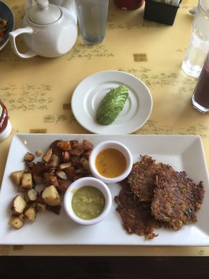 Zucchini potato pancakes with a side of avocado  at Cafe Evergreen in Nokomis