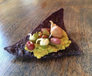 Here's one way to eat sprouted bean mix. Sprouted bean mix hummus on a tortilla chip, topped with sprouted beans! at Got Sprouts in Riviera Beach
