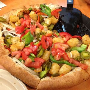 You can get tots on your pizza! Vegan pizza with tater tots added. at Woodstock's Pizza - Pacific Beach in San Diego