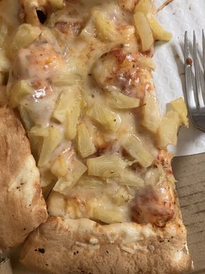 Half-eaten pineapple pizza with vegan cheese   at Woodstock's Pizza in San Luis Obispo