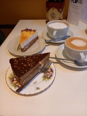 Chocolate mousse cake, White chocolademousse cake with apricot topping. Oats cappuccino, Hot chocolate with whipped cream at KLUTS in Utrecht