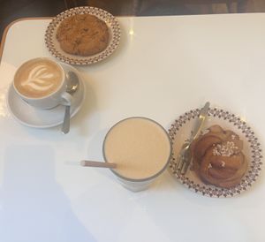 Cookie and cappuccino (right); cinnamon bun and iced latte (left)  at KLUTS in Utrecht