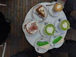Pandan cakes (bright green), matcha drinks (green), hot chocolate (the one with whipped cream), carrot cake with pistachio frosting, cappuccino at KLUTS in Utrecht