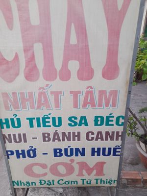 Faded old sign outside with menu at CHAY NHẤT TAM in Ho Chi Minh City