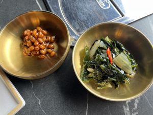 Side dishes. Soy beans on the left might have honey so please check if that concerns you    at Cahchi Korean BBQ Restaurant in New Malden