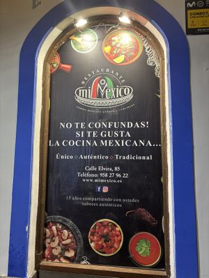 Sign outside confirming address and phone number   at Mi Méjico in Granada