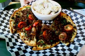 Vegan Pizza at the Petit Végo on the ground floor. This one has vegan minced 'meat', vegan cream cheese and lots of fennel seeds. I highly recommend it, but it is extremely filling. 

You should also take the (vegan) potato salad. It's amazing. at Resto Vego in Montreal