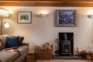 Sitting room with wood burner at Gorllan in Eglwyswrw
