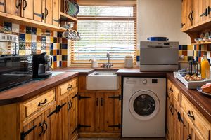 Kitchen with washing machine, small dishwasher, microwave, Nespresso machine etc at Gorllan in Eglwyswrw