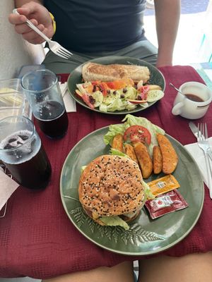 Al pastor burrito w/ side salad; vegan burger made from lentils, beans, peas, oats, carrot; w/ lettuce, tomato, onion, and jalapeños inside; comes w/ potato wedges. Agua de jamaic at Wake Up Vallarta in Puerto Vallarta