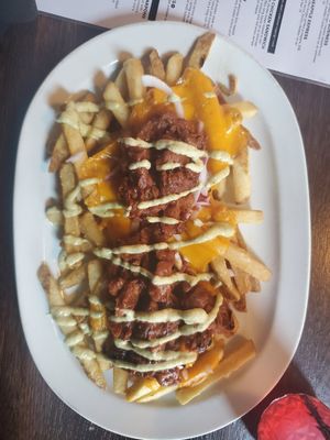 Fries Guy: Fries topped WITH BBQ jackfruit, vegan cheddar cheese, roasted jalapeño aioli at Puddlers Kitchen & Tap in Bridgeport