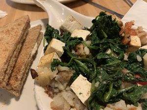 Tofu Scramble: Fresh spinach, tomatoes, and baked tofu on a bed of hashbrowns. Served with dry, whole-wheat toast  at Main Street Bistro in New Paltz