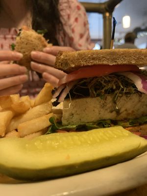 Tofu Today Sandwich. Fresh micro greens, portobello mushroom, salsa, tomato, and onion on top of baked tofu. Served with fries and a pickle  at Main Street Bistro in New Paltz