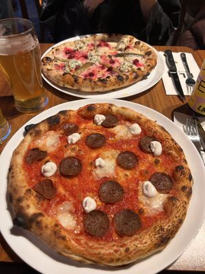 Salami pizza (seasonal christmas pizza in the background)  at FLIP - Vegan Pizza in Tampere