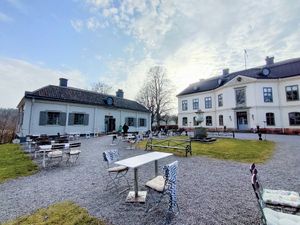 The cafe is the building on the left. The castle on the right. at Sturehofs Slottscafé in Norsborg
