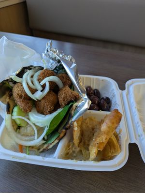 Falafel wrap with olives, pita, and hummus on the side at Arslans Gyros in Quartzsite