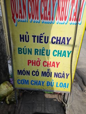 Vegan menu items on a sign outside at Du Món in Ho Chi Minh City