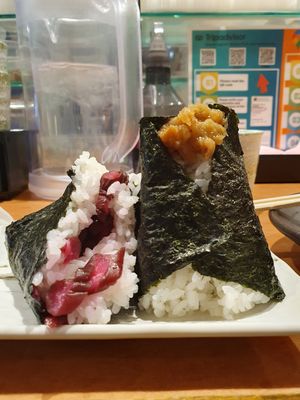Half eaten pickle onigiri and 1 bursting with delicious ume. at Onigiri Gorichan Tenjin in Fukuoka