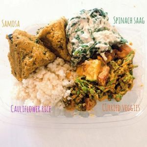 Raw Indian Bowl: almond veggie samosa, spinach cashew saag, curried veggies, and cauliflower rice at Healthy Being Juicery in Jackson
