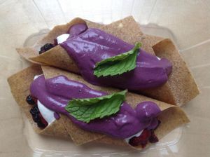 Delicious apple-flax crepe with mixed berries and coconut cream, topped with a gorgeous berry cashew cream! at Healthy Being Juicery in Jackson