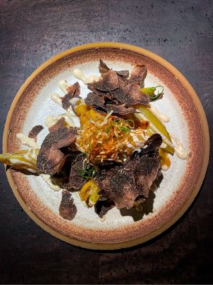 potato wedges with black truffle, fermented hazelnuts, fried onions and mayo-like cream  at Pramerl & the Wolf in Vienna