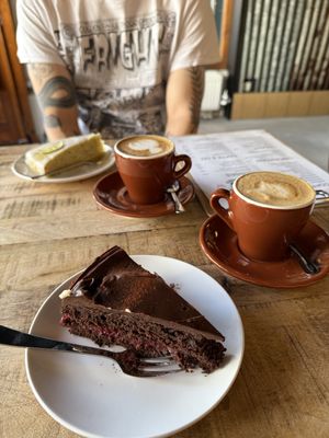 Chocolate raspberry cake and pistachio cake with small cappuccinos with oatmilk  at Smells Good Café in Essen