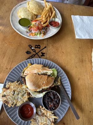 Two combo plates with 2 sides each. Above is the encassados with salad and fries; below is the black bean burger with beans and yukitas.  at Butterfly Brewing Co. & Imago Gastro Pub in Montezuma