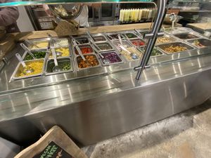 Adding the salad to the to-go box at Naked Lunch in Bryn Mawr