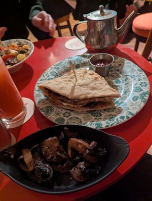 Sausage naan roll and side portion of mushrooms at Dishoom Permit Room in Cambridge