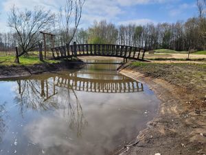 Bridge to the food forest and memorial at Sanctuary het Wijland in Darp
