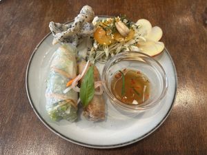 Vegetarian (appears to be vegan) starter: spring and summer rolls with light vinegar dipping sauce, together with sliced apple, lotus and tomato topped with fresh mint and cashew . at Petit Ete in Taichung